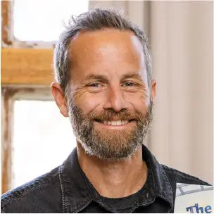 Kirk Cameron smiling with his Christian children's book, The Fox, the Fair, and the Invention Scare